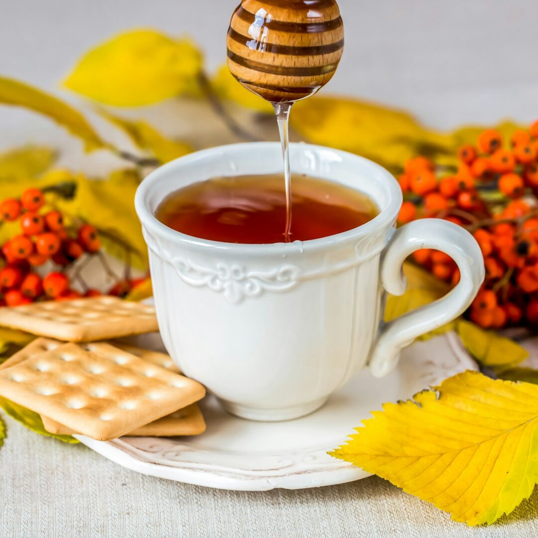 Tea with honey and autumn leafs