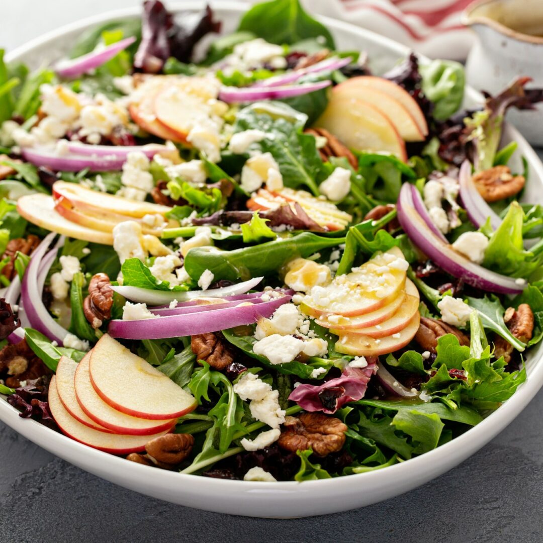 Winter salad with apple and pecans with vinaigrette dressing