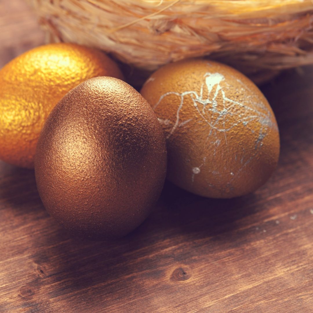 Gold Easter eggs on wooden background